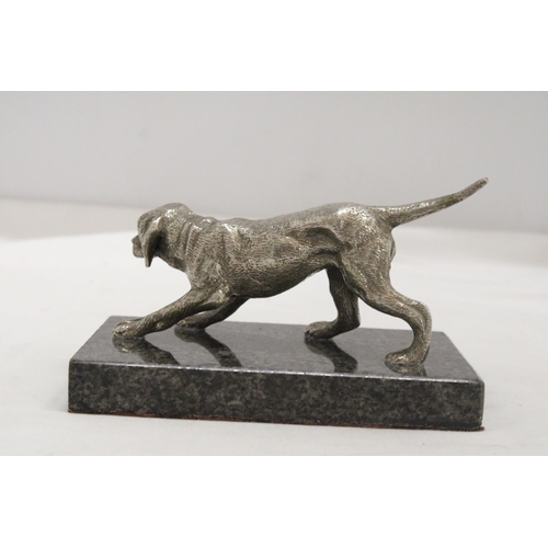 16 - A WHITE METAL DOG ON A MARBLE STAND