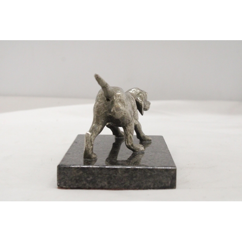 16 - A WHITE METAL DOG ON A MARBLE STAND