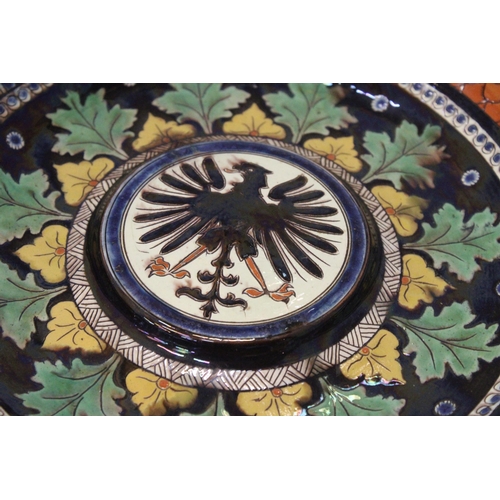 46 - AN AUSTRO-HUNGARIAN BLACK EAGLE MAJOLICA PLAQUE