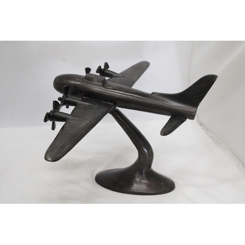 49 - A HEAVY METAL ART DECO STYLE BOMBER ON METAL PLINTH - 59 CM X 43 X 28