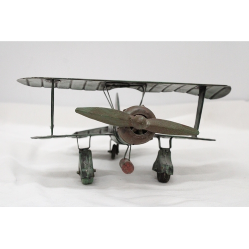 195 - A U.S.A TIN PLATE BI-PLANE APPROXIMATELY 13CM HIGH BY 23CM LONG