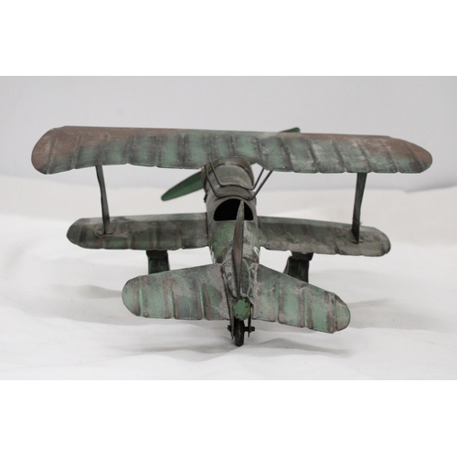 195 - A U.S.A TIN PLATE BI-PLANE APPROXIMATELY 13CM HIGH BY 23CM LONG