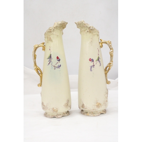 229 - A PAIR OF VICTORIAN JUGS IN IVORY WITH FLORAL AND GILT DECORATION - APPROXIMATELY 31CM HIGH