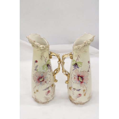 229 - A PAIR OF VICTORIAN JUGS IN IVORY WITH FLORAL AND GILT DECORATION - APPROXIMATELY 31CM HIGH