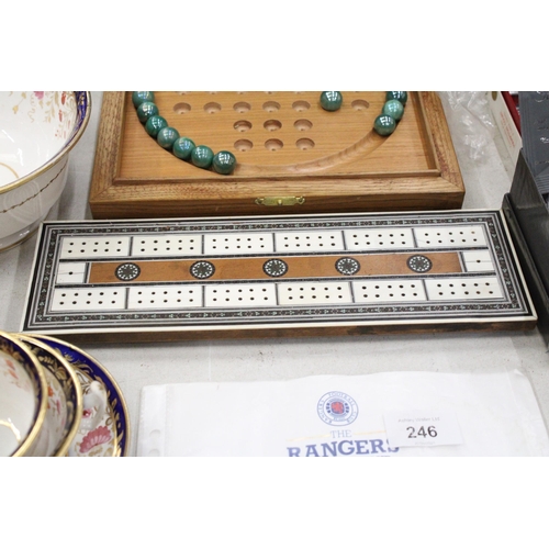 245 - A BOXED WOODEN SOLITAIRE BOARD WITH MARBLES PLUS A VINTAGE CRIBBAGE BOARD