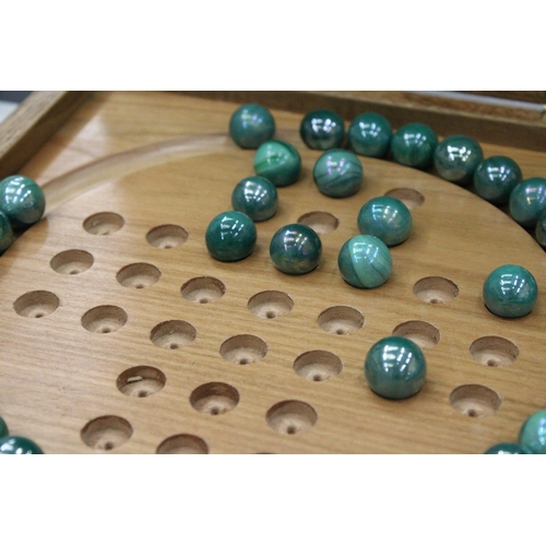 245 - A BOXED WOODEN SOLITAIRE BOARD WITH MARBLES PLUS A VINTAGE CRIBBAGE BOARD