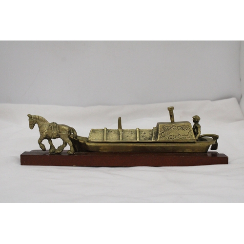 296 - A BRASS BARGE, BARGEE AND TOW HORSE ON A WOODEN BASE, LENGTH 30CM