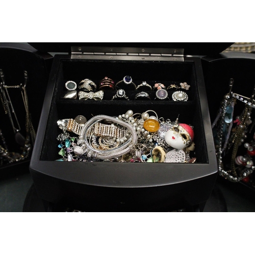 83 - A LARGE JEWELLERY BOX WITH DRAWERS AND DOORS CONTAINING A LARGE QUANTITY OF COSTUME JEWELLERY TO INC... 