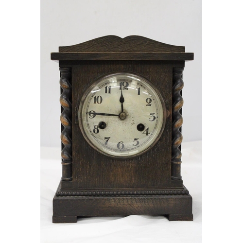 212 - A VINTAGE OAK CASED MANTLE CLOCK