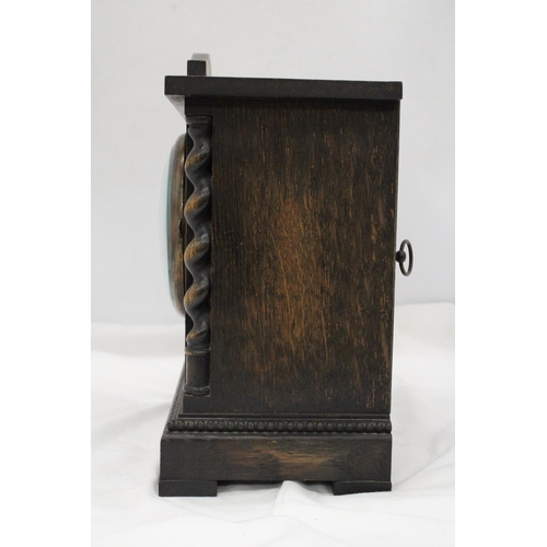 212 - A VINTAGE OAK CASED MANTLE CLOCK