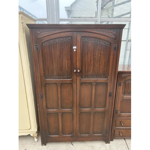 3110 - A REPRODUCTION OAK TWO DOOR WARDROBE WITH LINENFOLD PANELS, 46