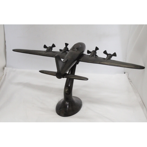 49 - A HEAVY METAL ART DECO STYLE MODEL OD A FOUR PROP AIRCRAFT ON METAL PLINTH - 59 CM X 43 X 28