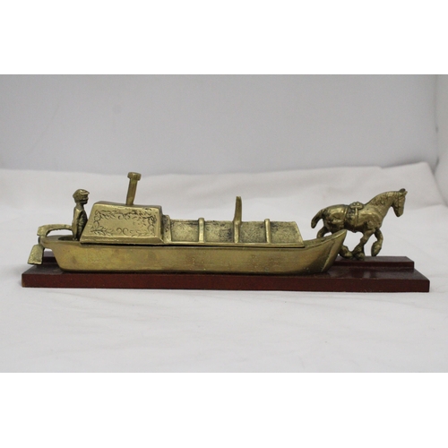 296 - A BRASS BARGE, BARGEE AND TOW HORSE ON A WOODEN BASE, LENGTH 30CM