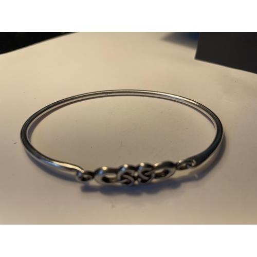 687 - A CELTIC SILVER BANGLE IN A PRESENTATION BOX