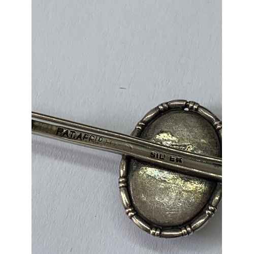 703 - A MARKED SILVER PIN BROOCH WITH LADY DECORATION