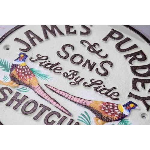 981 - A CAST 'JAMES PURDEY SHOTGUNS' SIGN, DIAMETER, 22CM