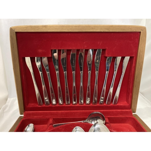 1058 - A CANTEEN OF CUTLERY IN AN OAK CASE