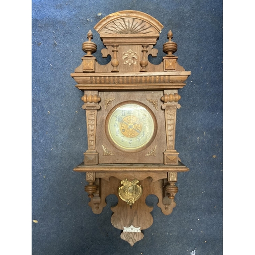 1060 - A VINTAGE OAK CASED WALL CLOCK, WITH CARVED DETAIL AND PENDULUM