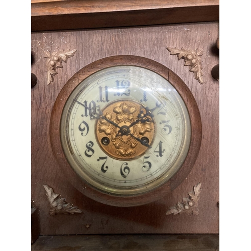 1060 - A VINTAGE OAK CASED WALL CLOCK, WITH CARVED DETAIL AND PENDULUM