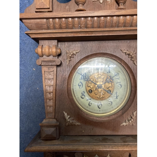 1060 - A VINTAGE OAK CASED WALL CLOCK, WITH CARVED DETAIL AND PENDULUM