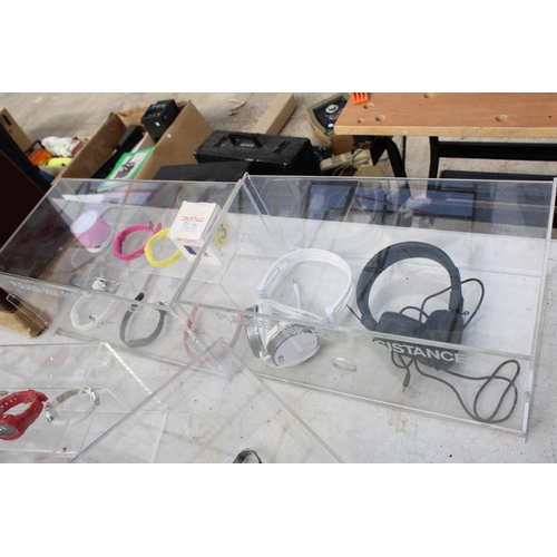 1711 - FOUR PLASTIC DISPLAY STANDS WITH AN ASSORTMENT OF FASHION WATCHES AND HEADPHONES