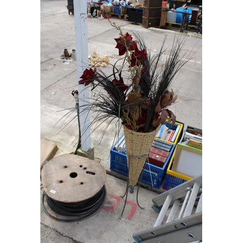 1867 - A METAL PLANT STAND WITH WICKER BASKET AND ARTIFICIAL FLOWERS