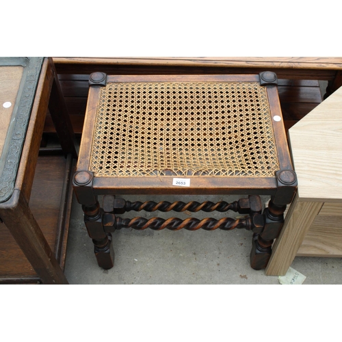 2653 - AN EARLY 20TH CENTURY OAK BARLEY-TWIST STOOL WITH CANE SEAT