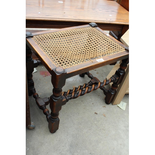 2653 - AN EARLY 20TH CENTURY OAK BARLEY-TWIST STOOL WITH CANE SEAT