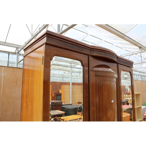 2950 - AN EDWARDIAN MAHOGANY PARTIALLY BOW FRONTED MIRROR-DOOR WARDROBE ON BRACKET FEET, 61