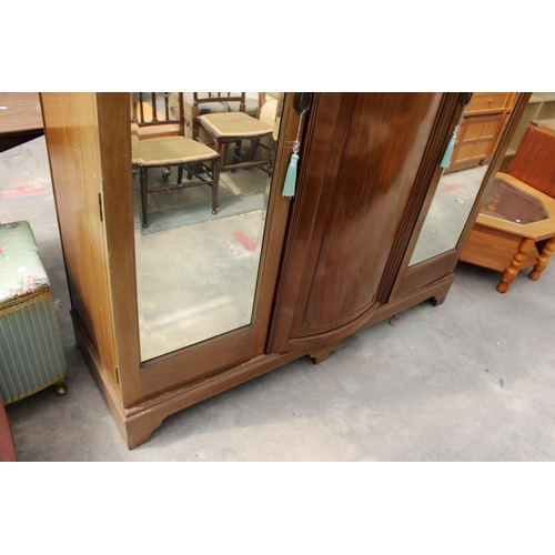 2950 - AN EDWARDIAN MAHOGANY PARTIALLY BOW FRONTED MIRROR-DOOR WARDROBE ON BRACKET FEET, 61