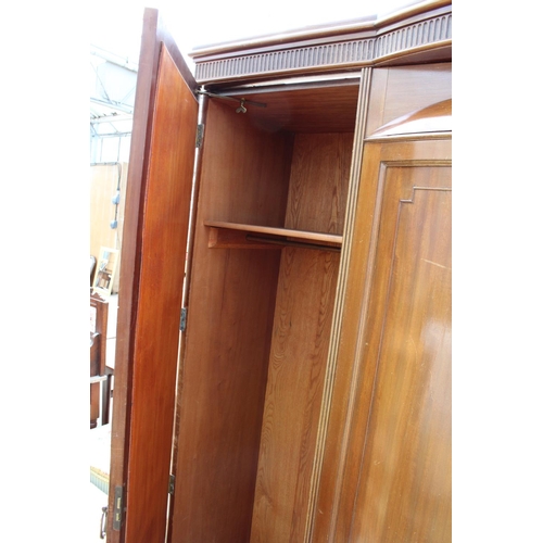 2950 - AN EDWARDIAN MAHOGANY PARTIALLY BOW FRONTED MIRROR-DOOR WARDROBE ON BRACKET FEET, 61