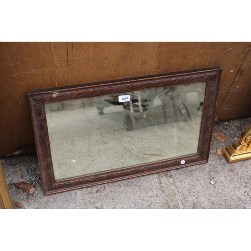 3063 - AN OAK FRAMED WALL MIRROR