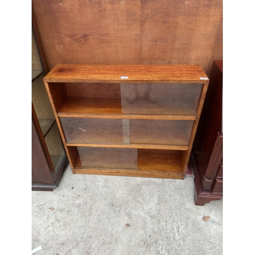 3114 - A MID 20TH CENTURY OAK BOOKCASE WITH GLASS SLIDING DOORS, 36