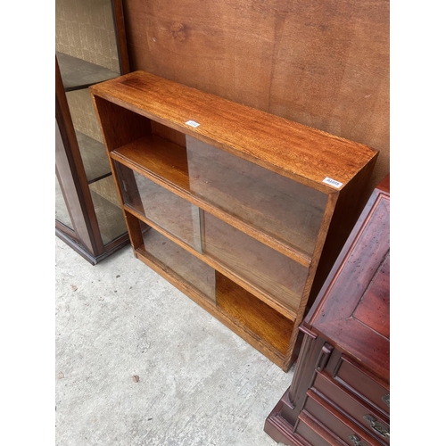 3114 - A MID 20TH CENTURY OAK BOOKCASE WITH GLASS SLIDING DOORS, 36