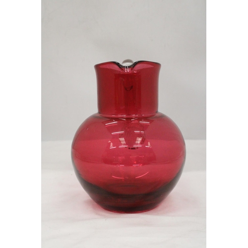 134 - A LARGE CRANBERRY GLASS JUG