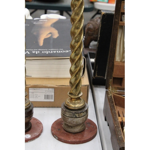 135 - A PAIR OF ANTIQUE BRASS CHURCH CANDLE HOLDERS