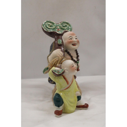 145 - A CHINESE PORCELAIN BUDDHA WITH CHILD