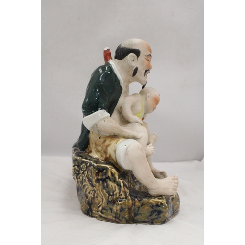 171 - A CHINESE PORCELAIN MAN WITH BABY