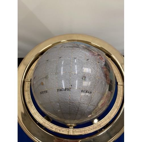 12 - A SEMI PRECIOUS STONE GLOBE ON A BRASS STAND WITH COMPASS