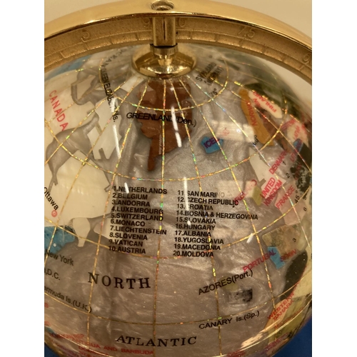 12 - A SEMI PRECIOUS STONE GLOBE ON A BRASS STAND WITH COMPASS