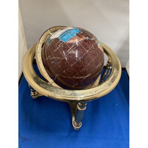 42 - A SEMI PRECIOUS STONE GLOBE ON A BRASS STAND WITH COMPASS