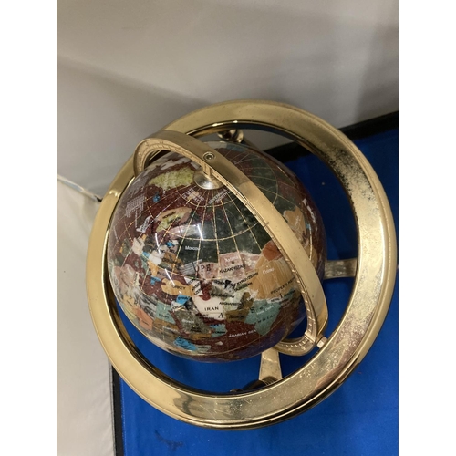 42 - A SEMI PRECIOUS STONE GLOBE ON A BRASS STAND WITH COMPASS