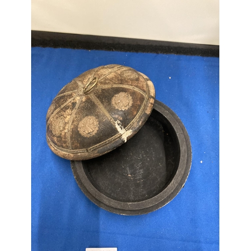 48 - A VINTAGE INDIAN ROUND WOODEN OPIUM/TOBACCO BOX DECORATED WITH HAMMERED METAL FLOWERS