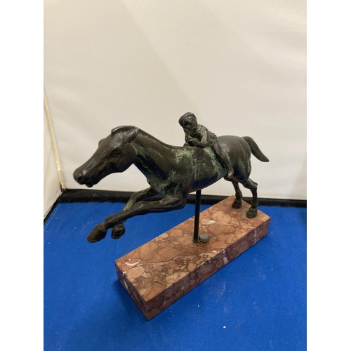 57 - A BRONZE FIGURE OF A YOUNG BOY ON A RACE HORSE DEPICTING THE JOCKEY OF ARTEMISION ON A MARBLE BASE