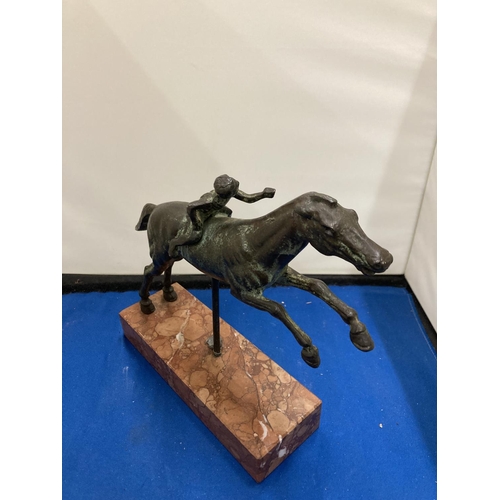 57 - A BRONZE FIGURE OF A YOUNG BOY ON A RACE HORSE DEPICTING THE JOCKEY OF ARTEMISION ON A MARBLE BASE