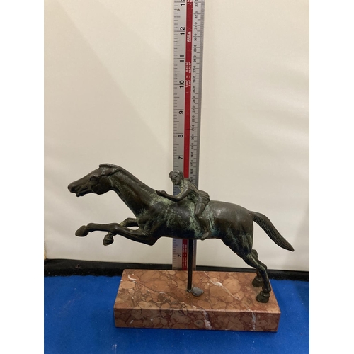 57 - A BRONZE FIGURE OF A YOUNG BOY ON A RACE HORSE DEPICTING THE JOCKEY OF ARTEMISION ON A MARBLE BASE