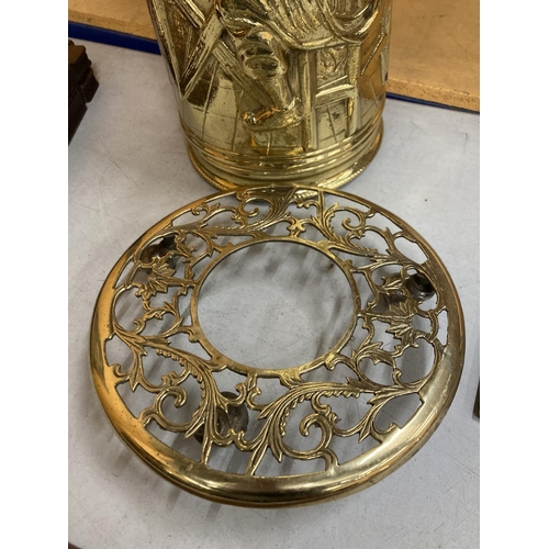 63 - TWO BRASS ITEMS TO INCLUDE A TALL STICK STAND AND A TRIVET ON WHEELS