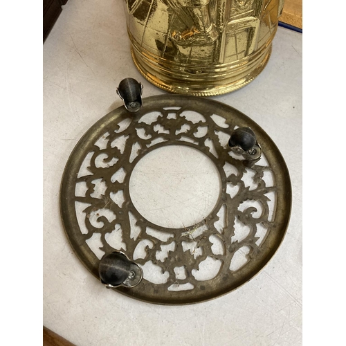 63 - TWO BRASS ITEMS TO INCLUDE A TALL STICK STAND AND A TRIVET ON WHEELS