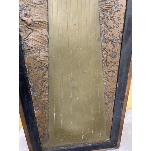 69 - A LARGE BRASS RUBBING PLATE IN A WOODEN FRAME DEPICTING A LADY IN MEDIEVAL DRESS 3'5