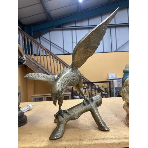 73 - A LARGE HEAVY BRASS EAGLE ON A LOG